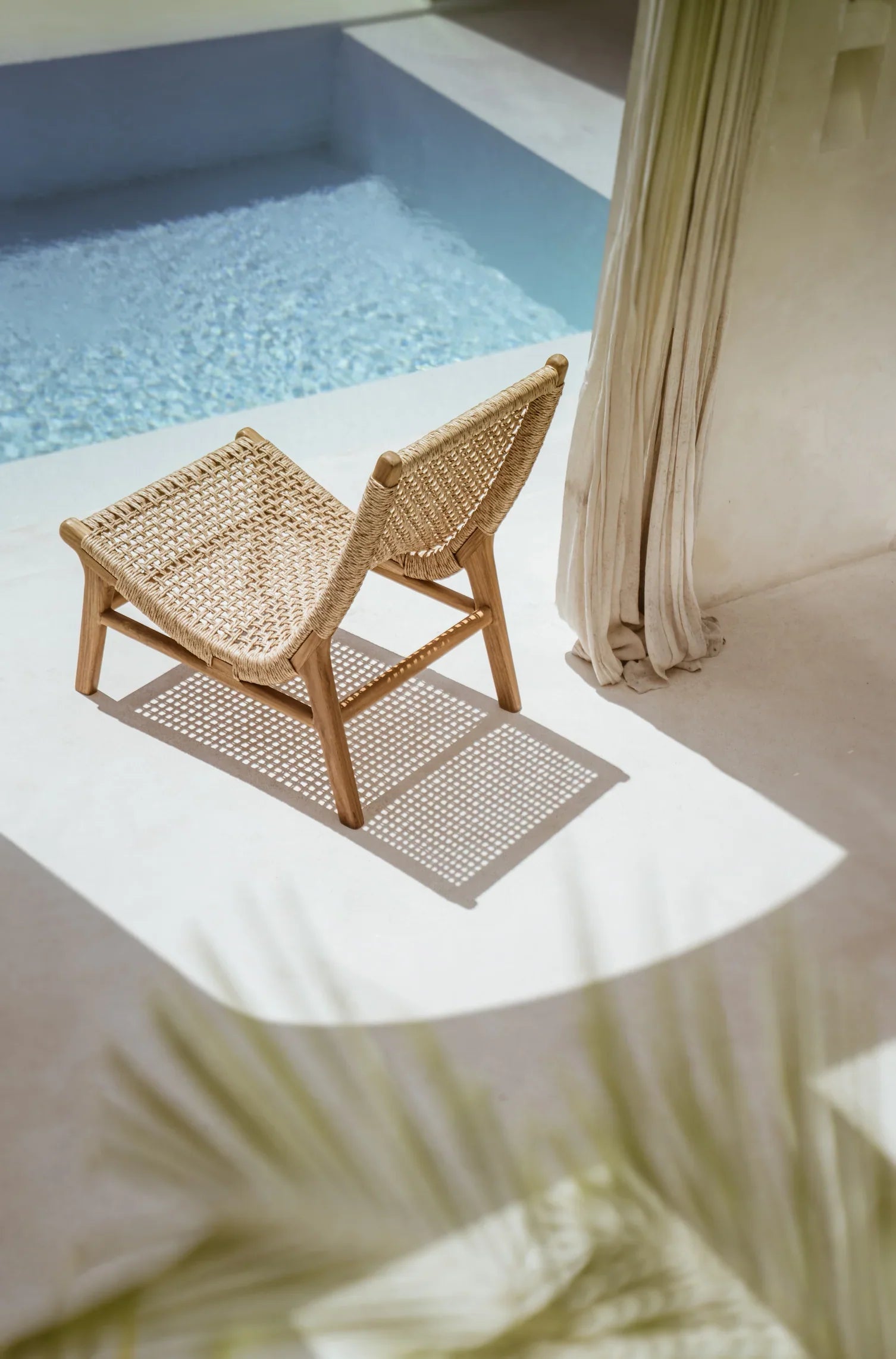 Teak and rattan lounge chair outside in Bali