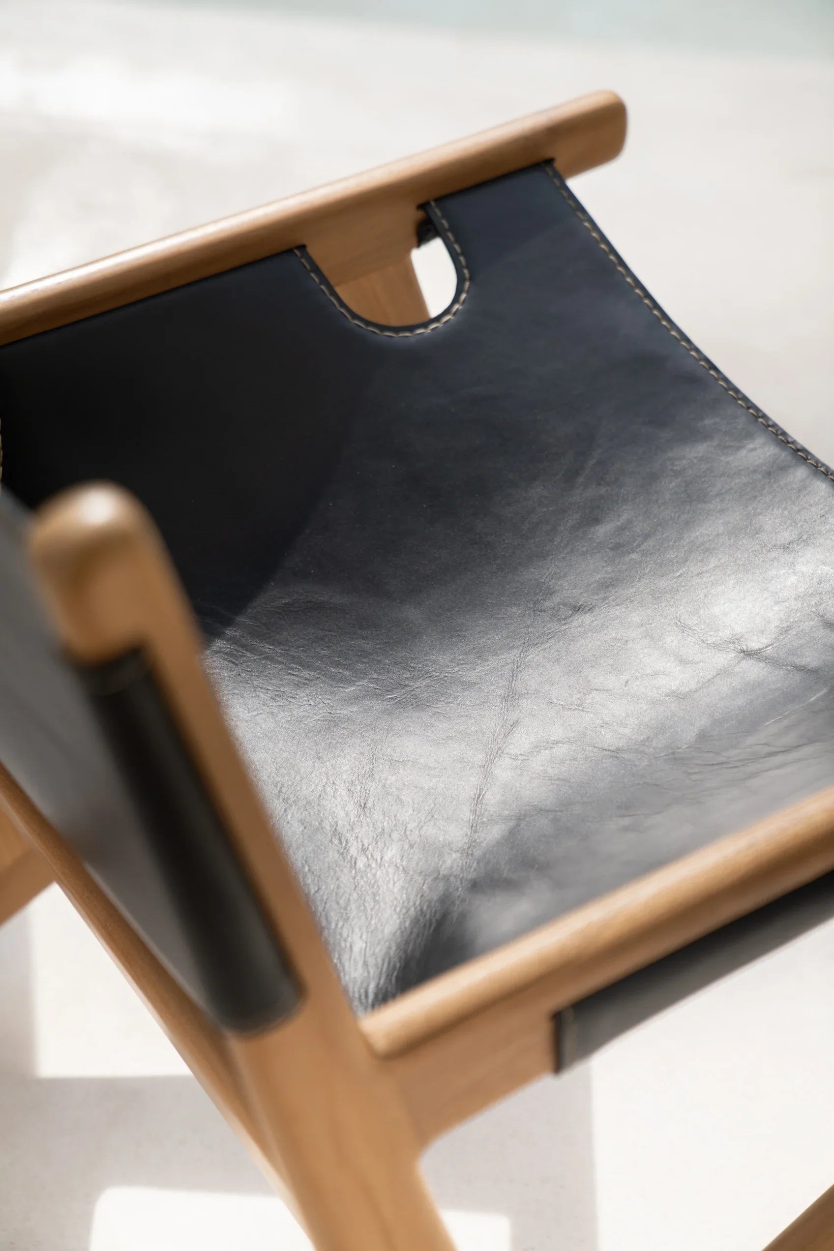 Black leather and teak lounge chair