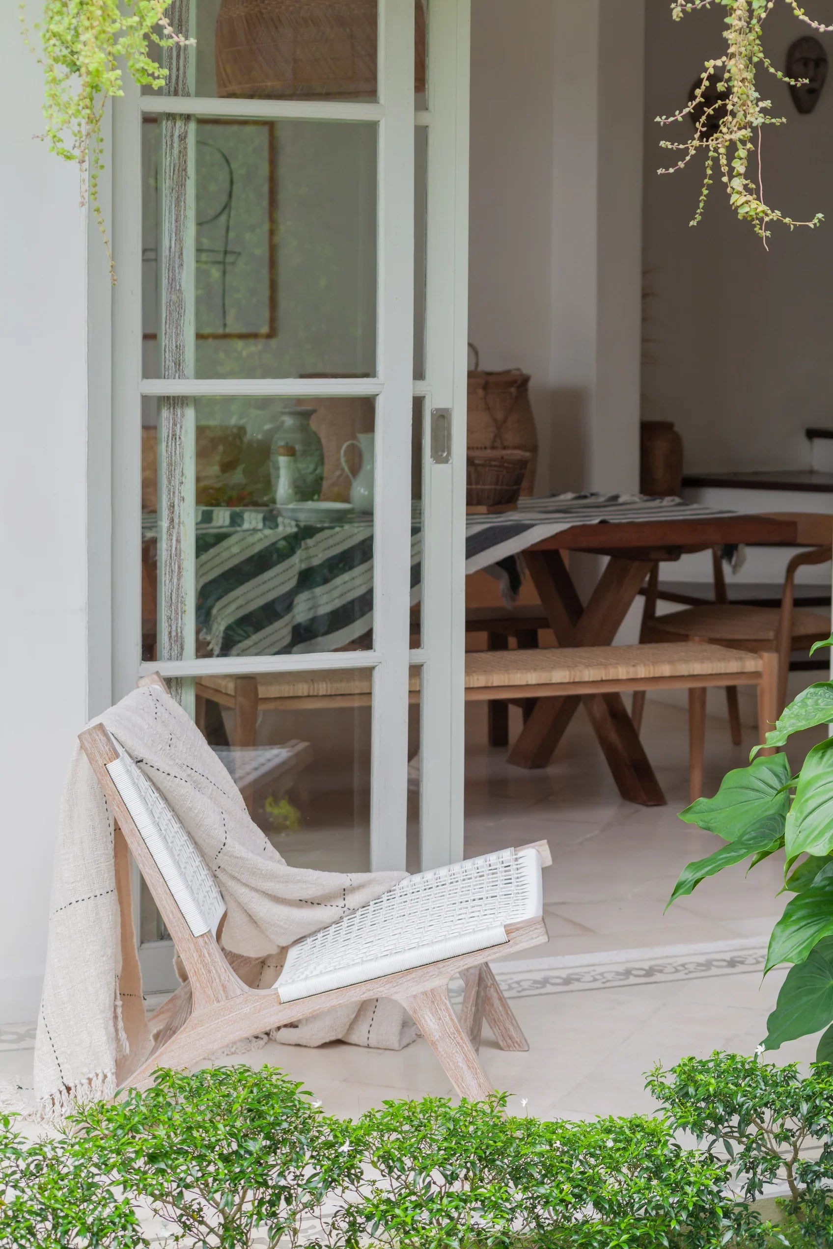 white rattan and teak chair on patio