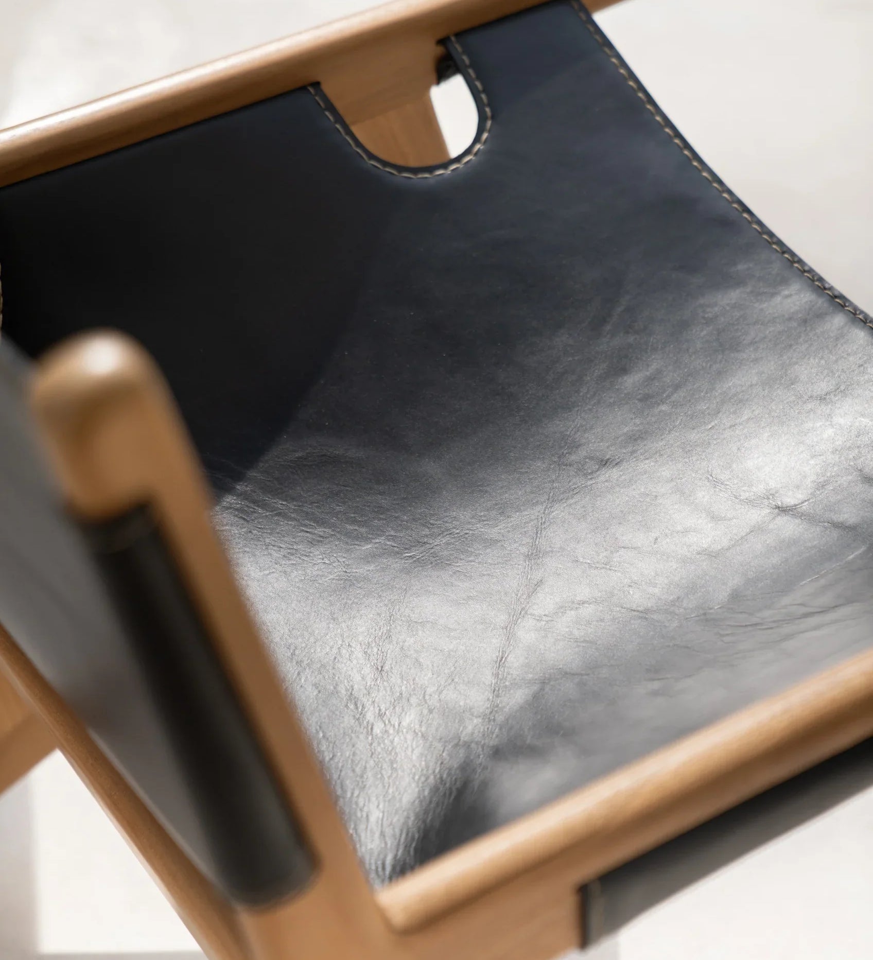 Black leather and teak lounge chair