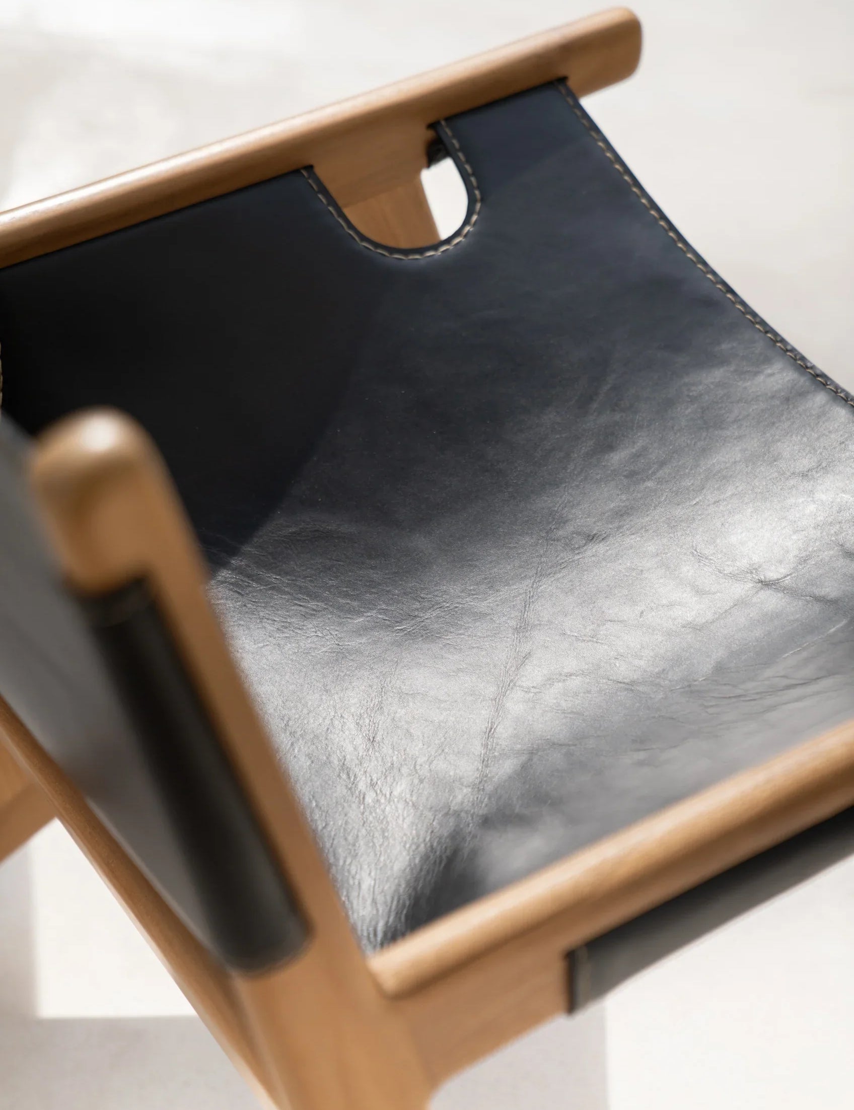 Black leather and teak lounge chair