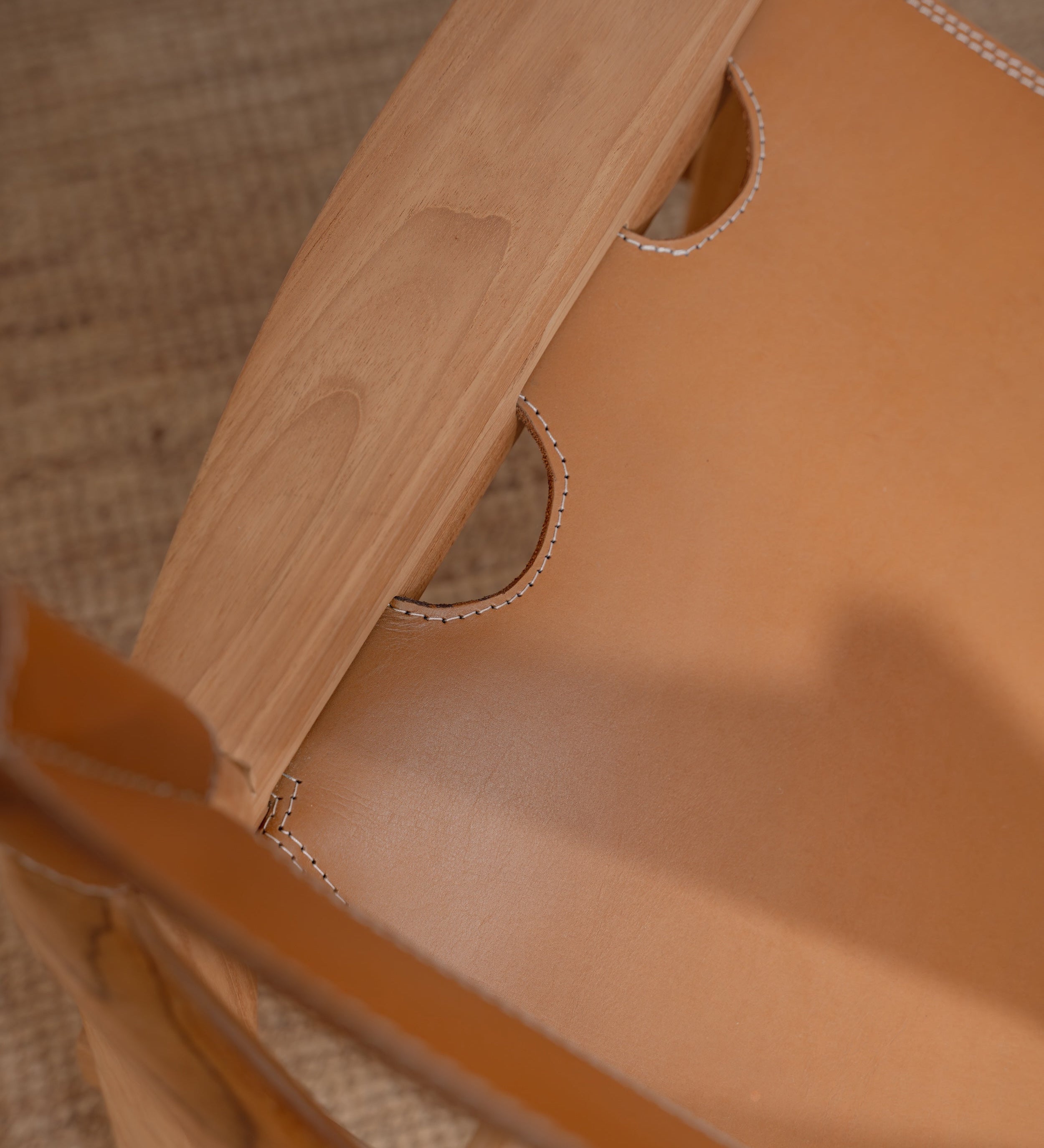 closeup of a leather and teak lounge chair