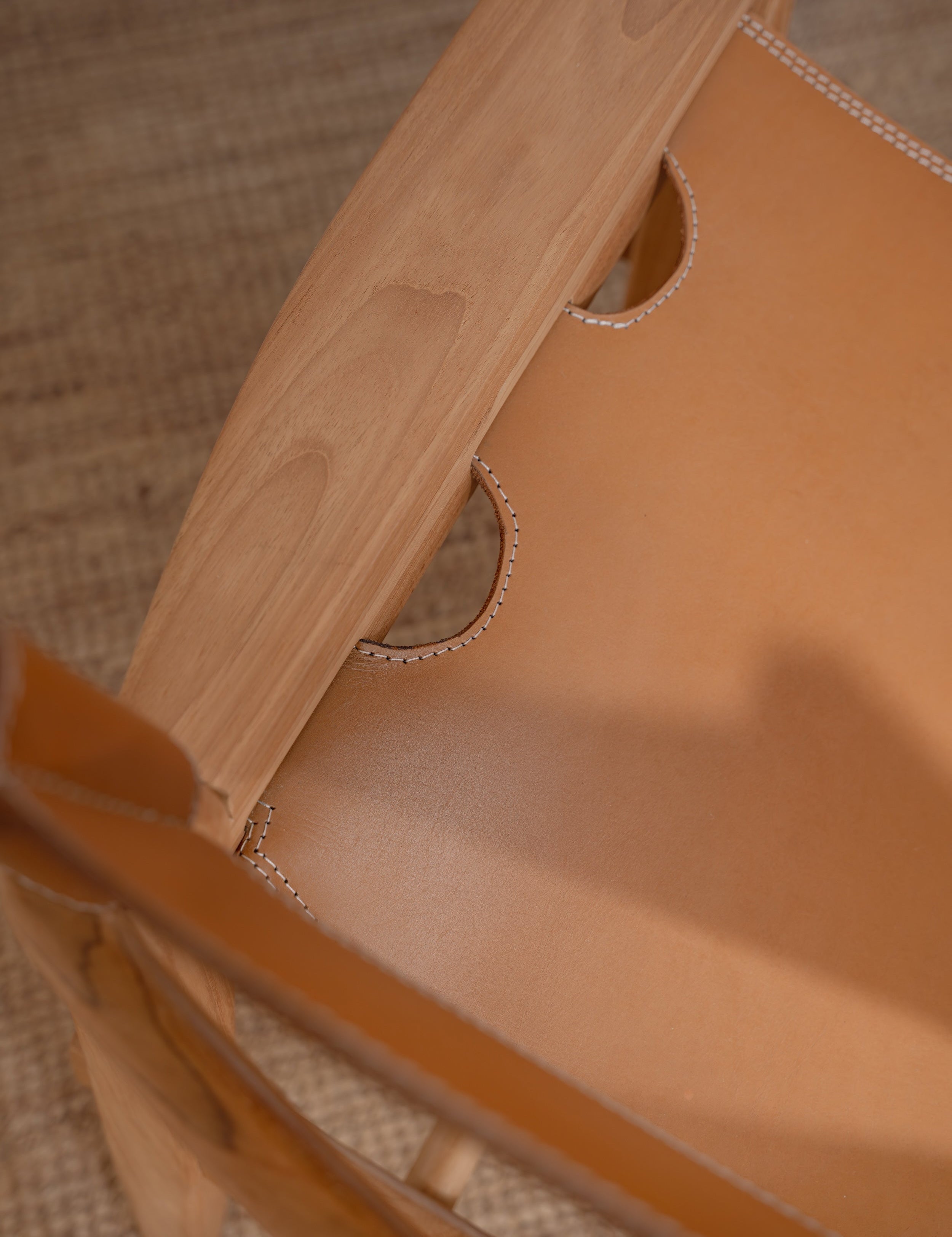 closeup of a leather and teak lounge chair