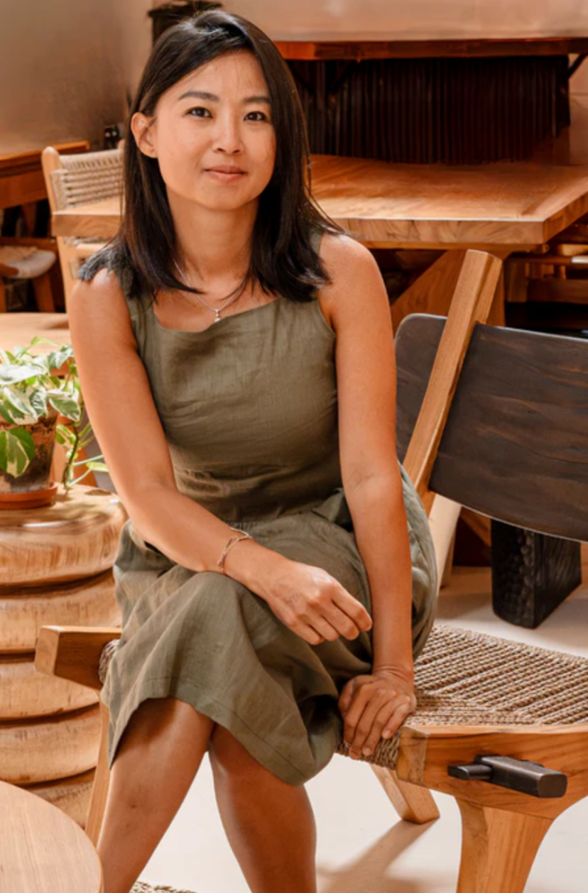 A woman is sitting on a chair smiling