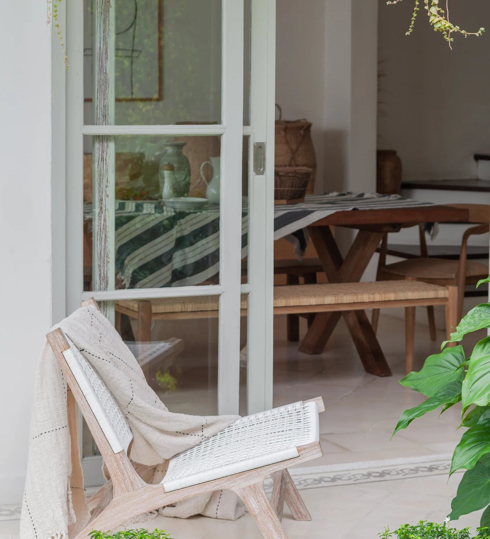 white rattan and teak chair on patio