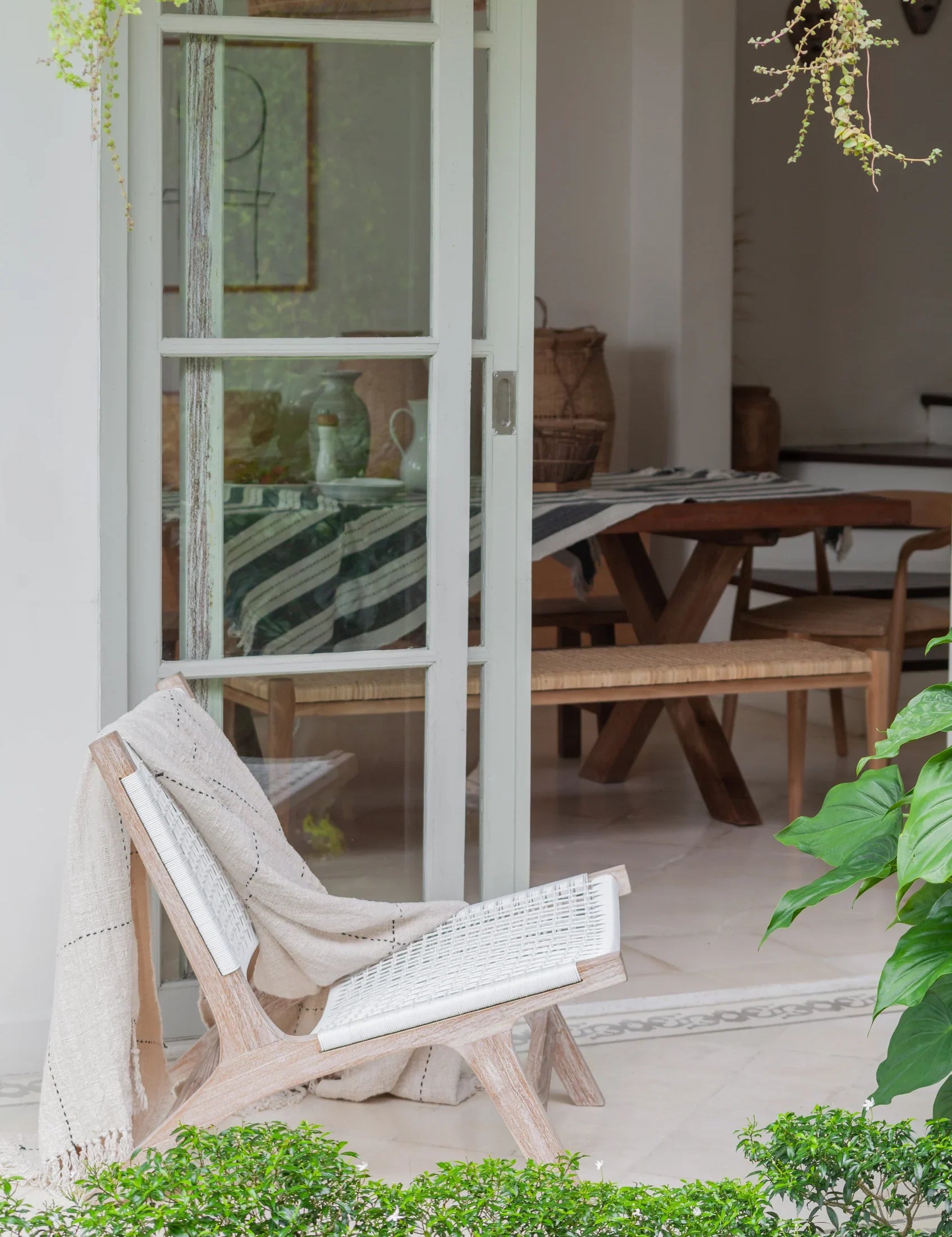 white rattan and teak chair on patio