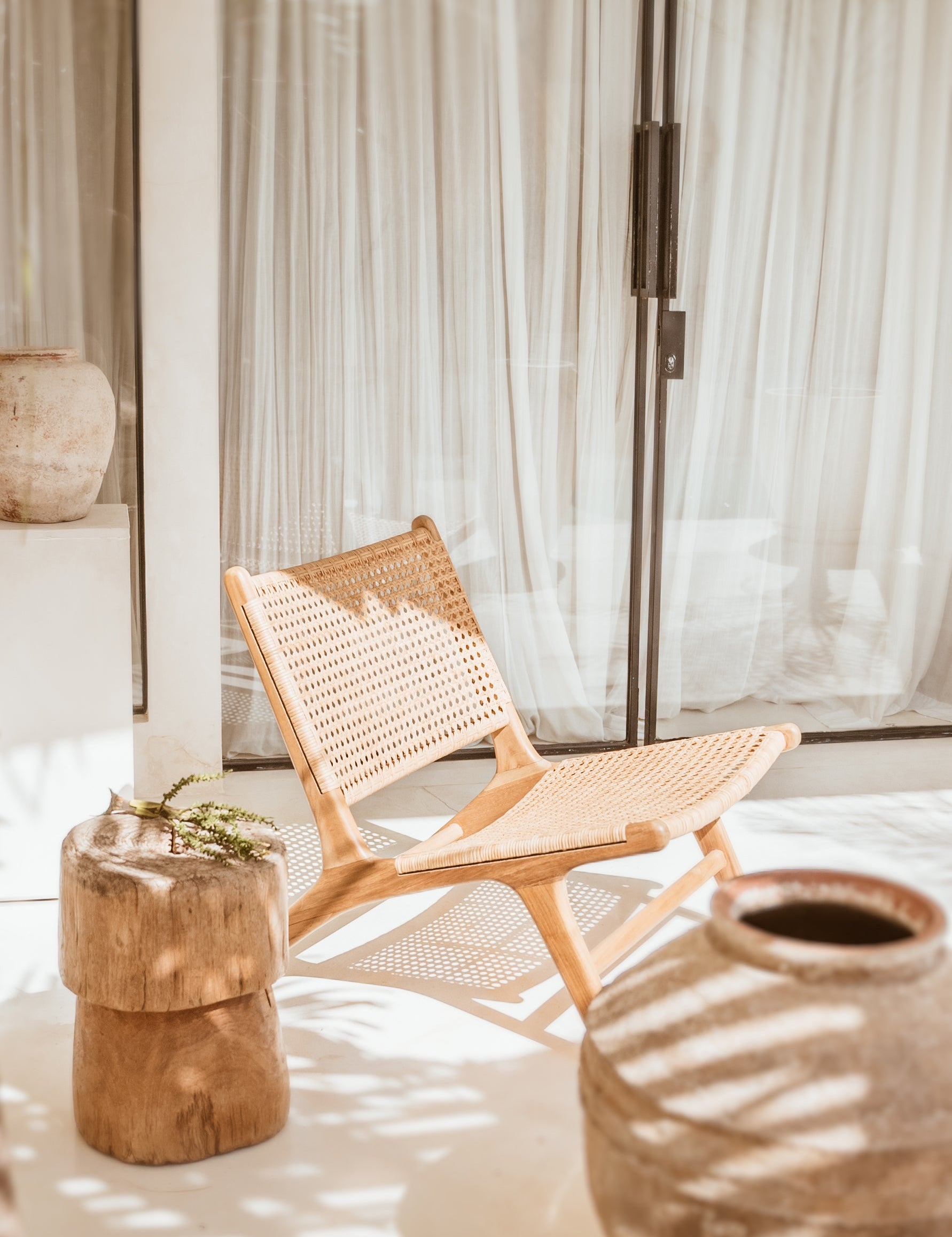 Teak and rattan lounge chair outside