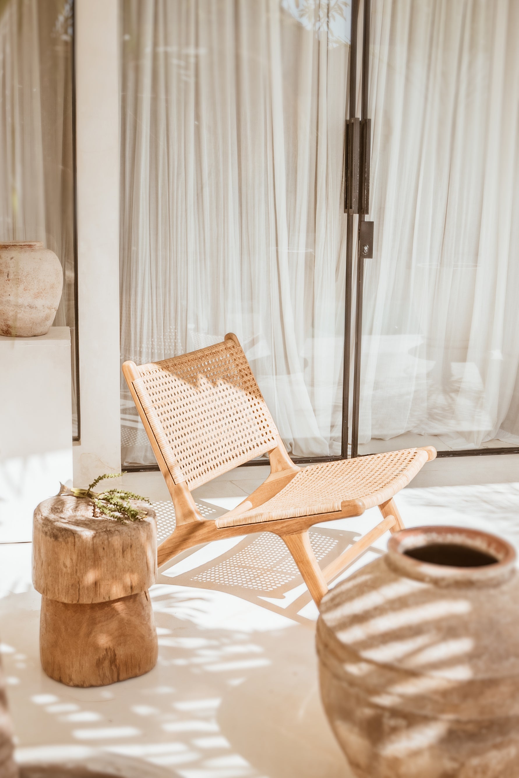 Teak and rattan lounge chair outside