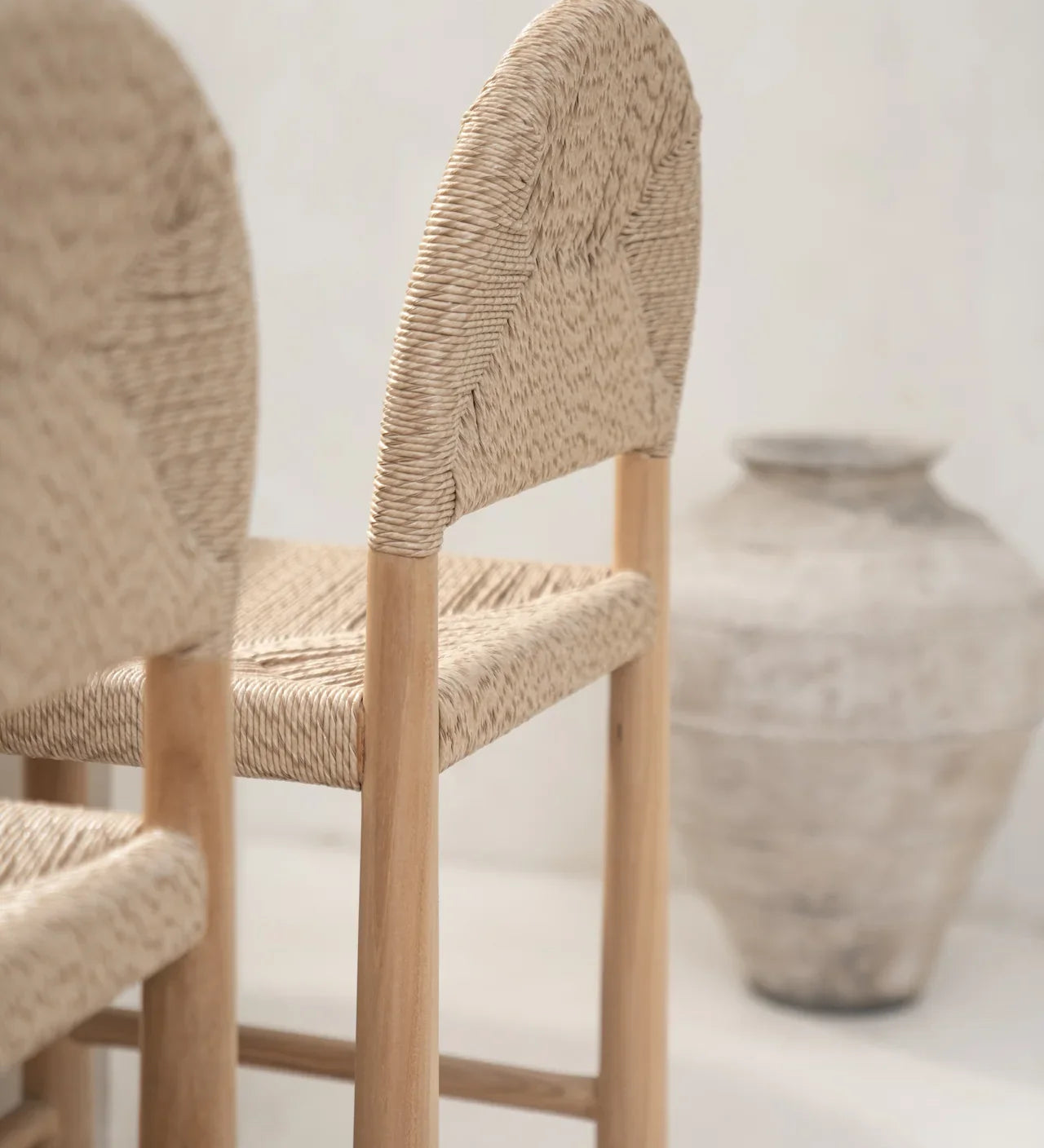 neutral interior with rattan and teak kitchen stools