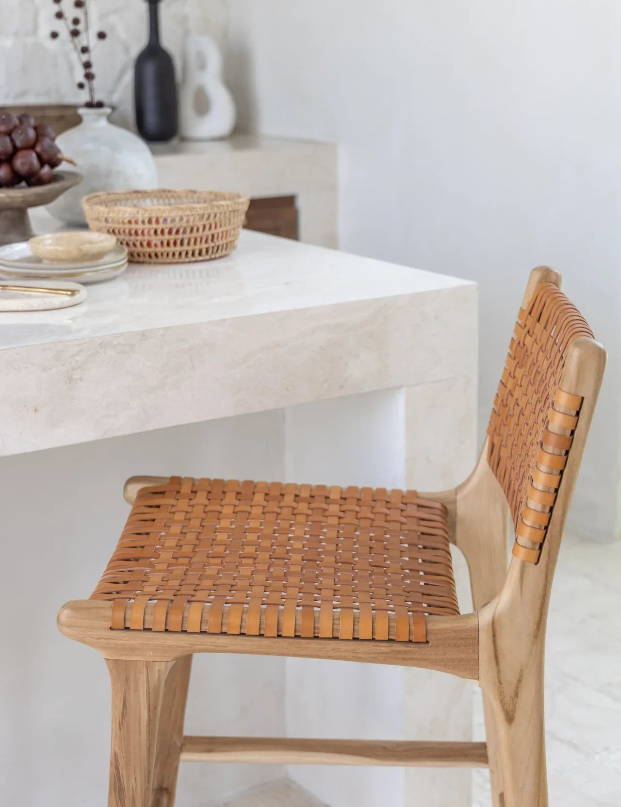 leather and teak kitchen stool in a white kitchen in bali