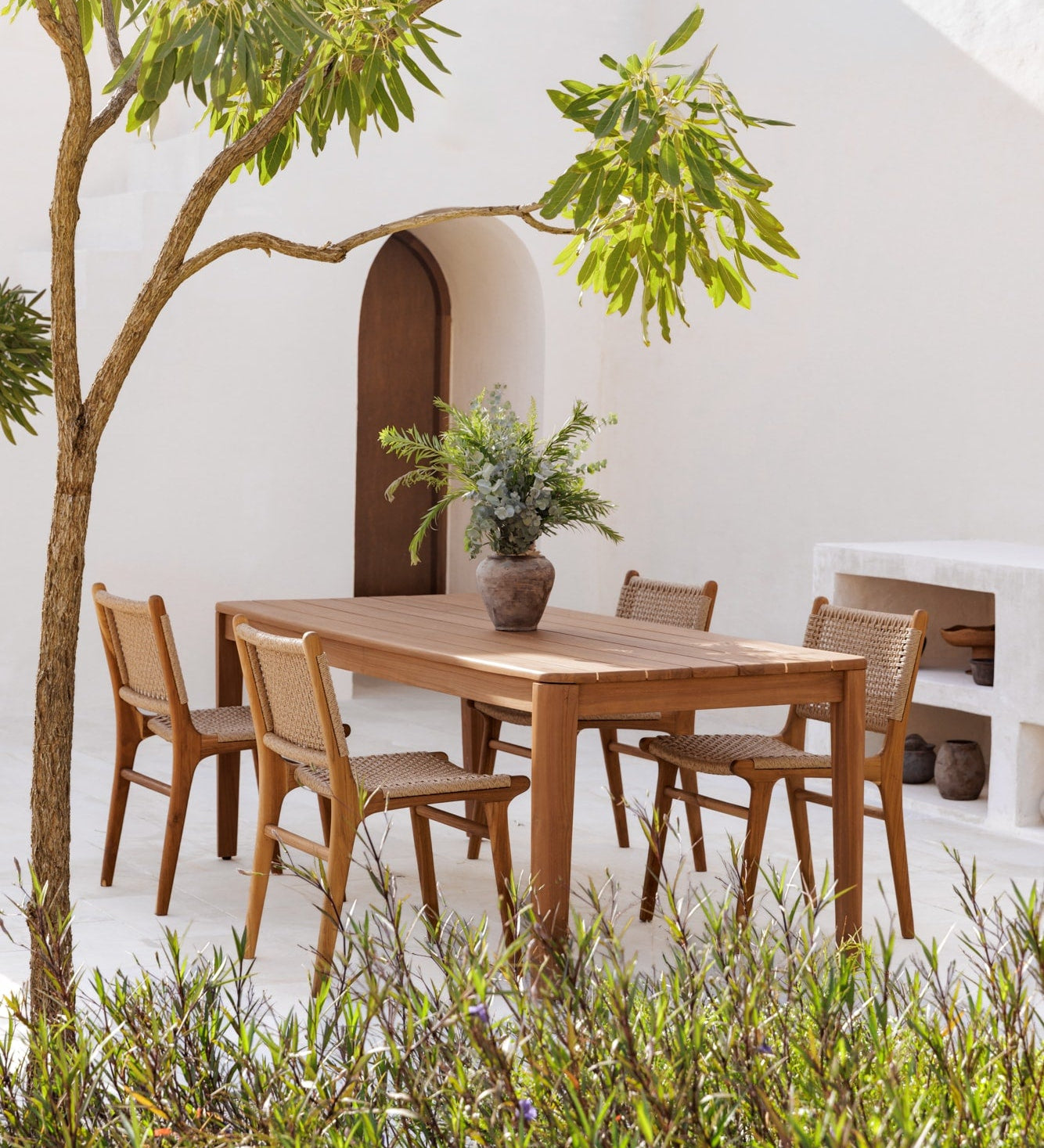 teak table outdoors with matching dining chairs