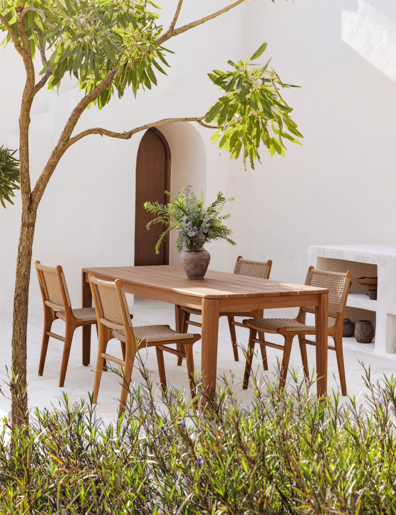 teak table outdoors with matching dining chairs