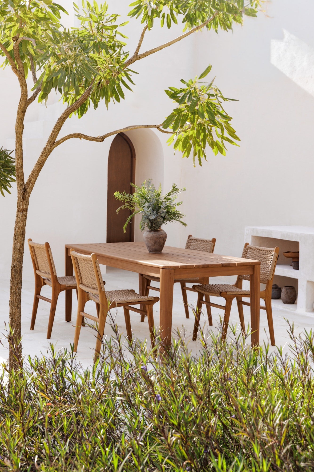 teak table outdoors with matching dining chairs