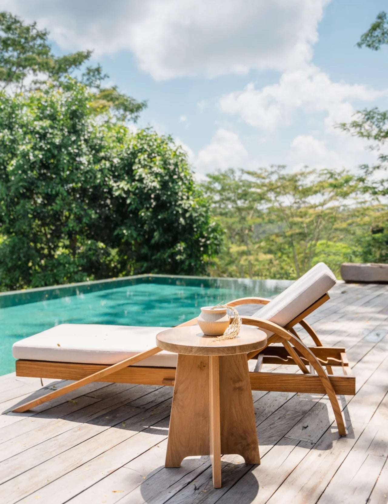 teak sun lounger and pool in bali