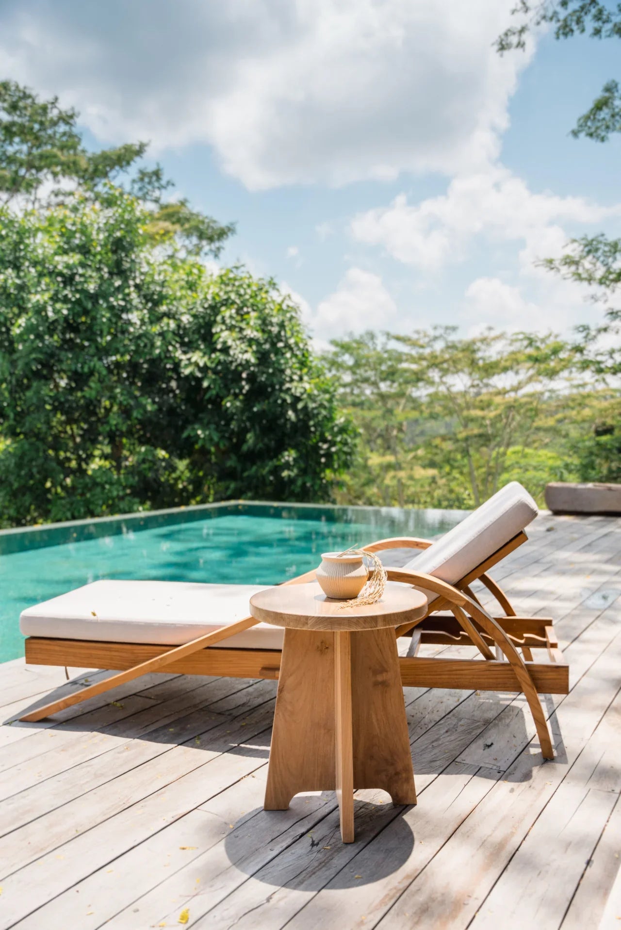 teak sun lounger and pool in bali