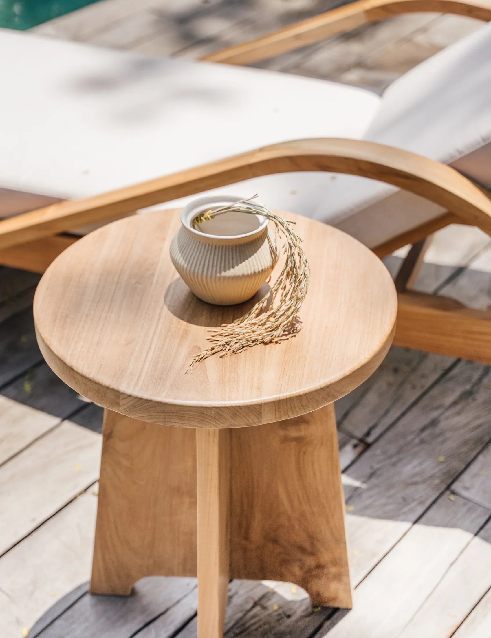 teak side table by a pool in bali