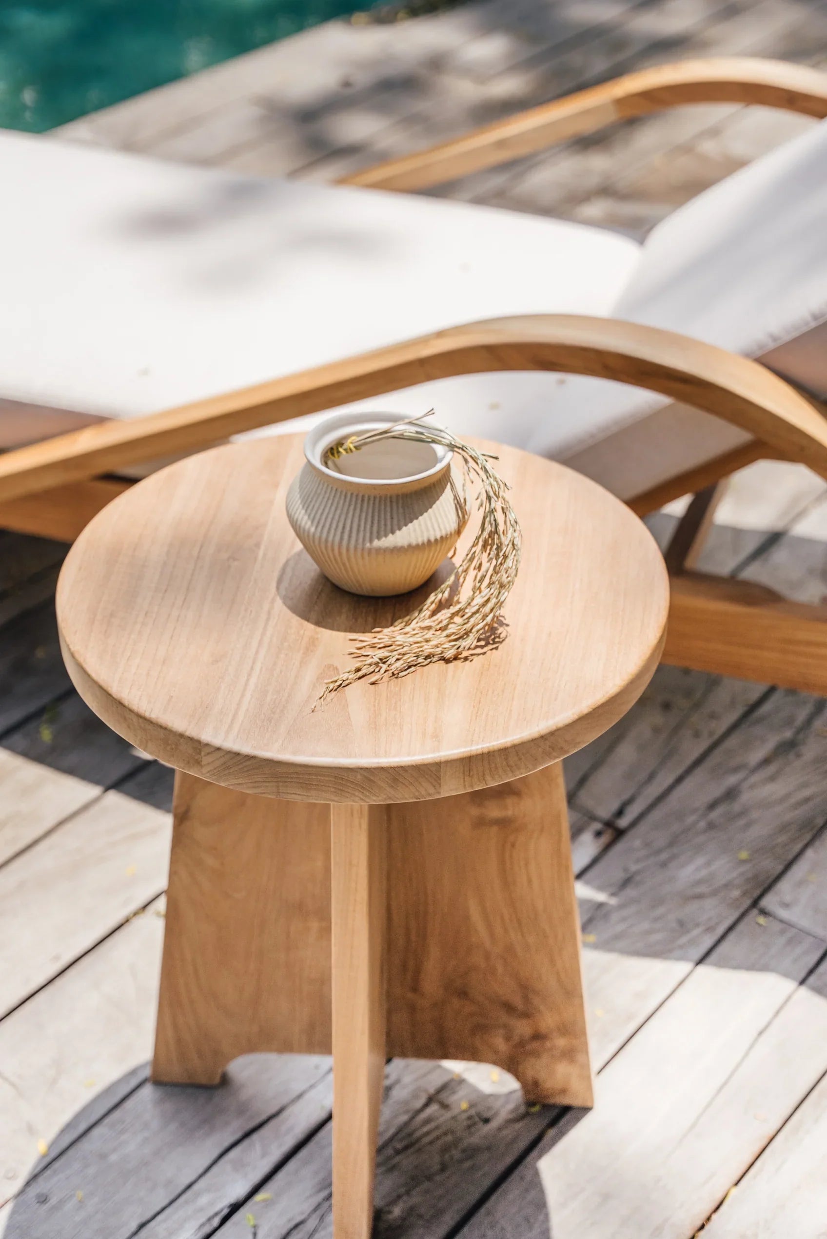 teak side table by a pool in bali