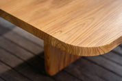Close-up of a wooden table with a blurred background