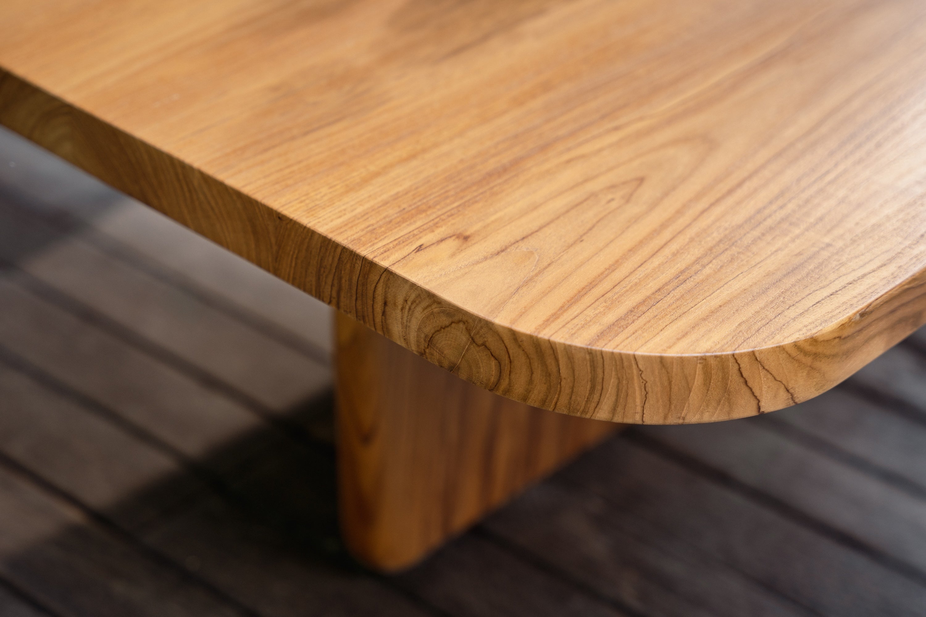 Close-up of a wooden table with a blurred background